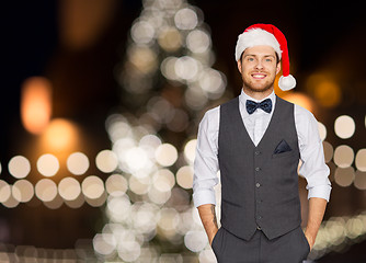 Image showing happy man in santa hat and suit at christmas