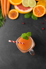 Image showing mason jar glass of fruit juice on slate table top