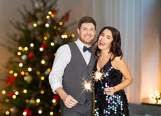 Image showing happy couple with sparklers at christmas party