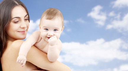 Image showing mother with baby over sky background