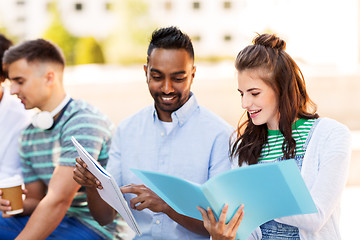 Image showing international students with notebooks outdoors