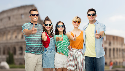 Image showing friends showing thumbs up over coliseum background