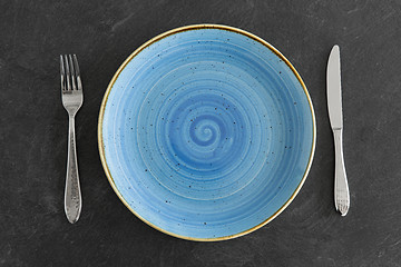 Image showing close up of plate, fork and knife on table