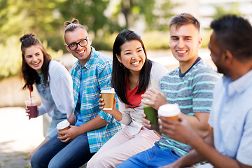 Image showing friends drinking coffee and juice talking in city