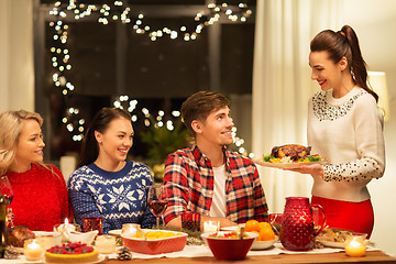 Image showing happy friends having christmas dinner at home