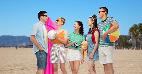 Image showing happy friends with beach and summer accessories