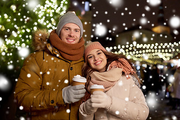 Image showing happy young couple with coffee at christmas market