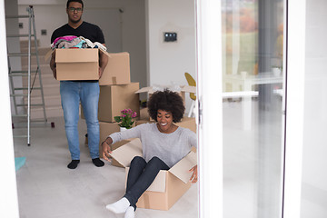 Image showing African American couple  playing with packing material