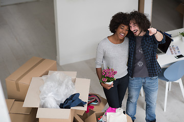 Image showing multiethnic couple moving into a new home