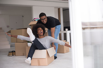 Image showing African American couple  playing with packing material