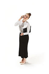 Image showing Full length portrait of a smiling female teacher holding a folder isolated against white background