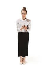 Image showing Full length portrait of a smiling female teacher holding a folder isolated against white background