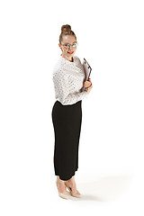 Image showing Full length portrait of a smiling female teacher holding a folder isolated against white background