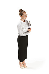 Image showing Full length portrait of a smiling female teacher holding a folder isolated against white background