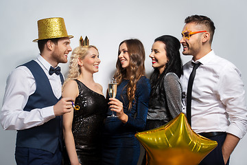 Image showing happy friends with golden party props posing