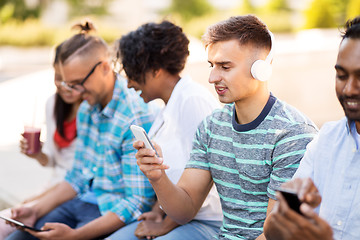 Image showing man with friends listening to music on smartphone