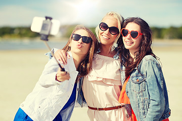 Image showing group of smiling women taking selfie on beach