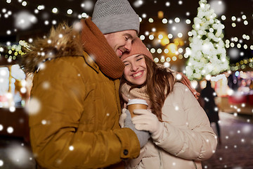 Image showing happy young couple with coffee at christmas market