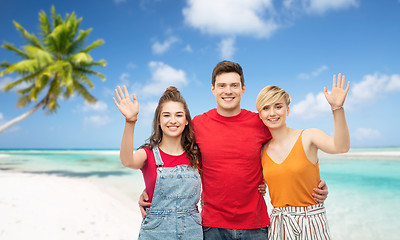 Image showing happy friends hugging over beach background