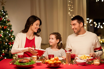 Image showing happy family having christmas dinner at home