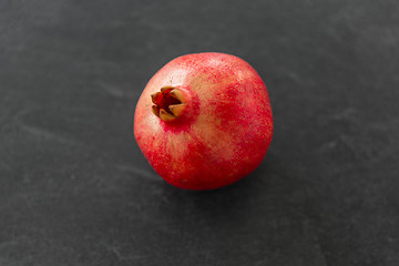 Image showing close up of pomegranate on stone table