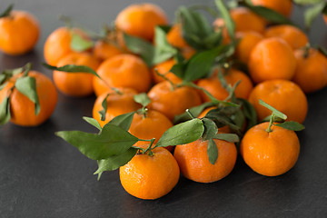 Image showing close up of mandarins on slate table top