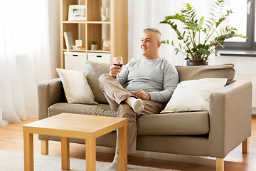 Image showing man drinking red wine from glass at home