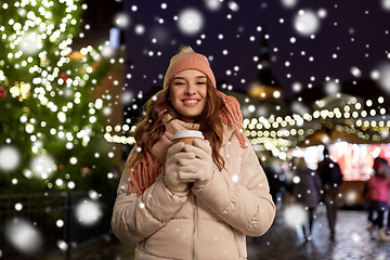 Image showing happy young woman with coffee at christmas market