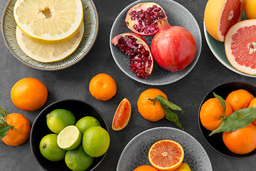 Image showing close up of citrus in bowls fruits on stone table