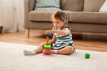 Image showing happy baby girl playing with toy blocks at home