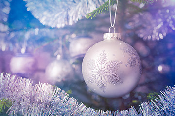 Image showing Christmas-tree decoration bauble on decorated Christmas tree bac