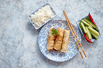 Image showing Orginal asian deep fried spring rolls placed on beautiful oriental style plate