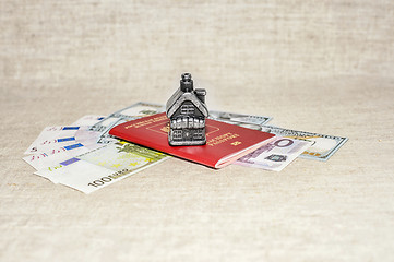 Image showing Passport, money and home - the concept of buying a property