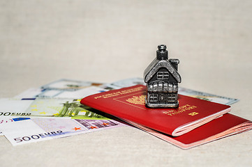 Image showing Passport, money and home - the concept of buying a property