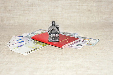 Image showing Passport, money and home - the concept of buying a property