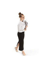 Image showing Full length portrait of a smiling female teacher holding a folder isolated against white background