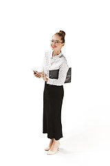 Image showing Full length portrait of a smiling female teacher holding a folder isolated against white background