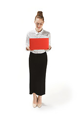 Image showing Full length portrait of a smiling female teacher holding a laptop isolated against white background