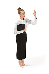 Image showing Full length portrait of a female teacher holding a folder isolated against white background