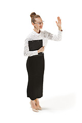 Image showing Full length portrait of a female teacher holding a folder isolated against white background