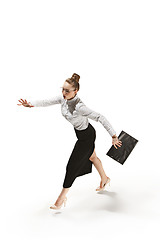 Image showing Full length portrait of a smiling female teacher holding a folder isolated against white background