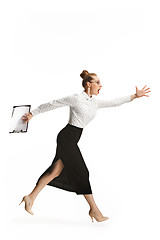 Image showing Full length portrait of a smiling female teacher holding a folder isolated against white background