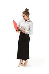 Image showing Full length portrait of a smiling female teacher holding a laptop isolated against white background