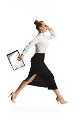 Image showing Full length portrait of a smiling female teacher holding a folder isolated against white background