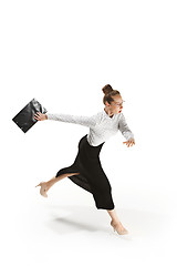 Image showing Full length portrait of a smiling female teacher holding a folder isolated against white background