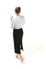 Image showing Full length portrait of a back of female teacher holding a folder isolated against white background