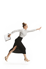 Image showing Full length portrait of a smiling female teacher holding a folder isolated against white background