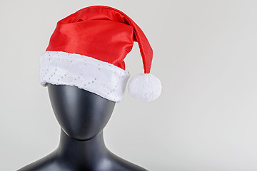 Image showing A head of female mannequin with santa claus hat isolated on white background.