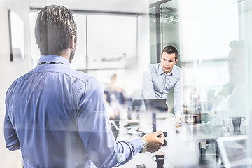 Image showing Business team brainstorming on meeting in modern corporate office.