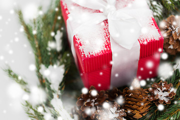 Image showing close up of christmas gift and fir wreath on snow